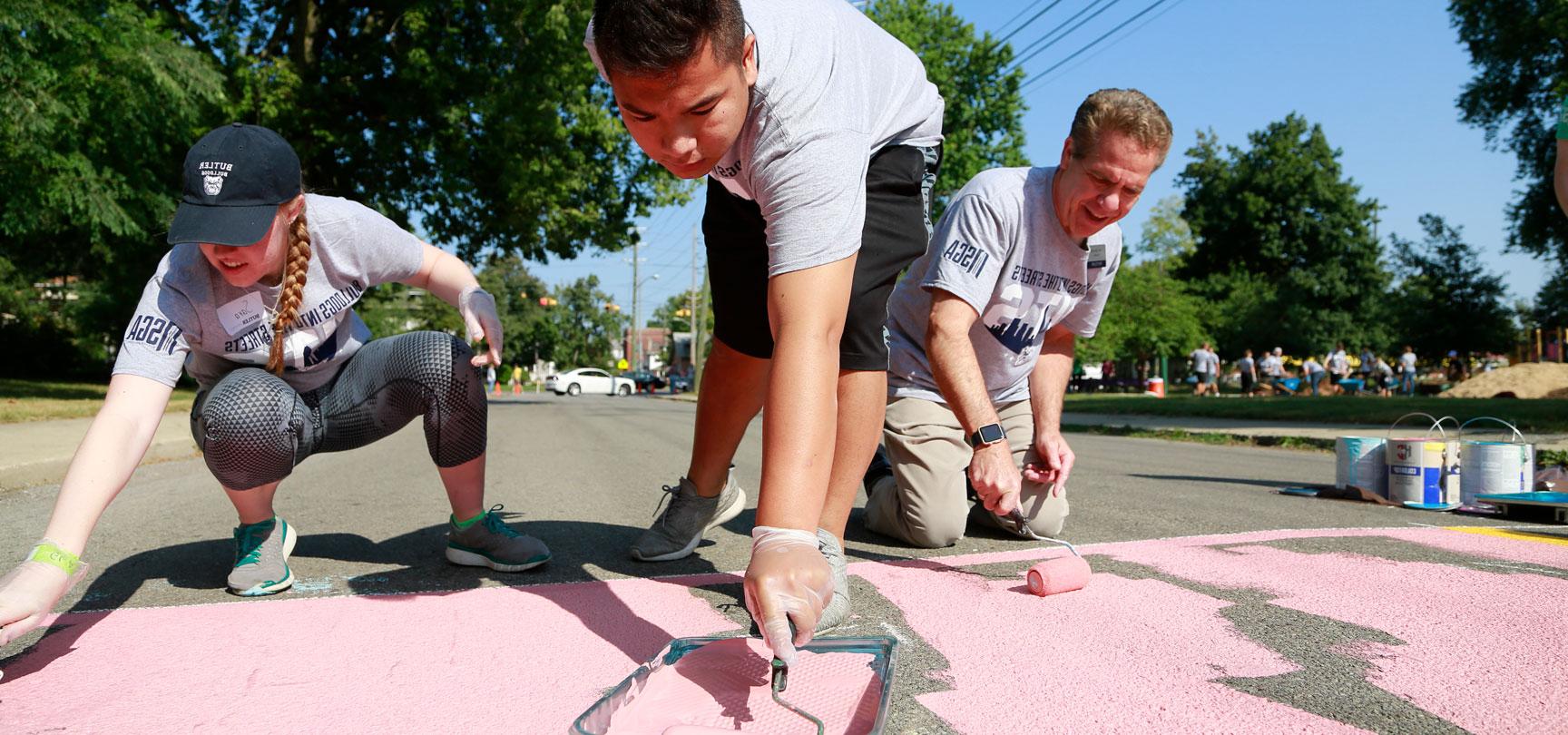 Students and President Danko painting