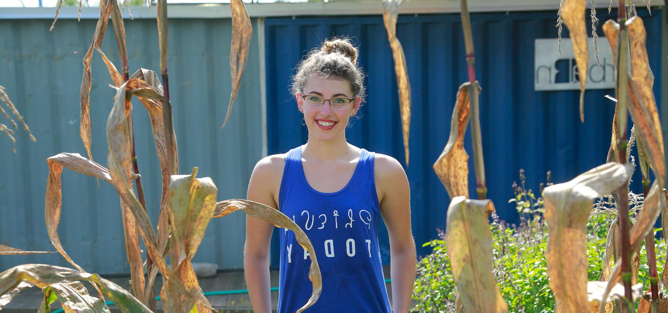 Student standing in a garden